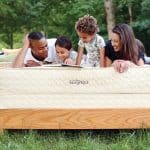 Family relaxing on Savvy Rest's Serenity organic mattress