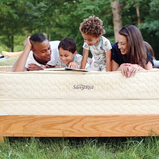 Family relaxing on Savvy Rest's Serenity organic mattress