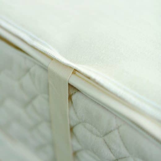 natural organic Wool mattress pad has a snug fit on mattress